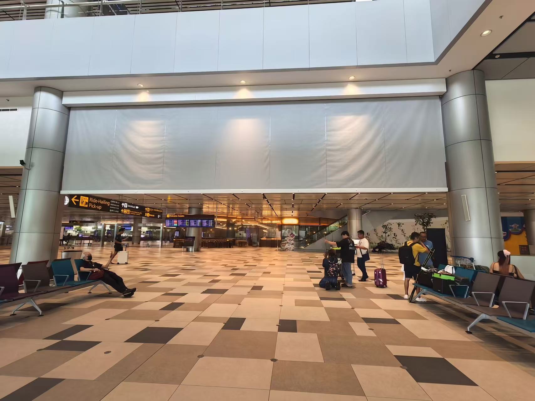 Automatic fire curtain system installed in a modern airport terminal for commercial fire safety and compartmentation.